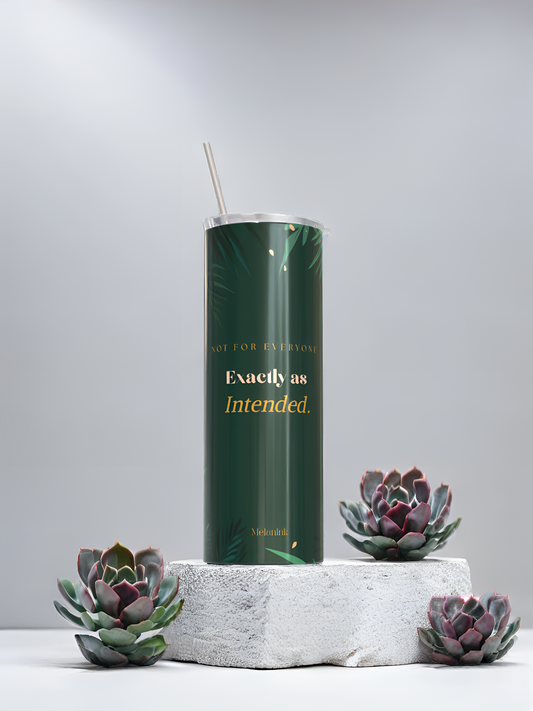 MelanInk Designs Emerald Garden 20oz sublimation tumbler from the Bloom & Dusk Collection. Deep emerald green wrap design with gold botanical palm leaf detail and layered gold typography. Displayed on a white textured stone pedestal with green and purple succulent plants. Clean minimal grey background. Handcrafted and pressed to order in Atlanta Georgia. Black owned small business. Sublimation tumbler gift for her.
